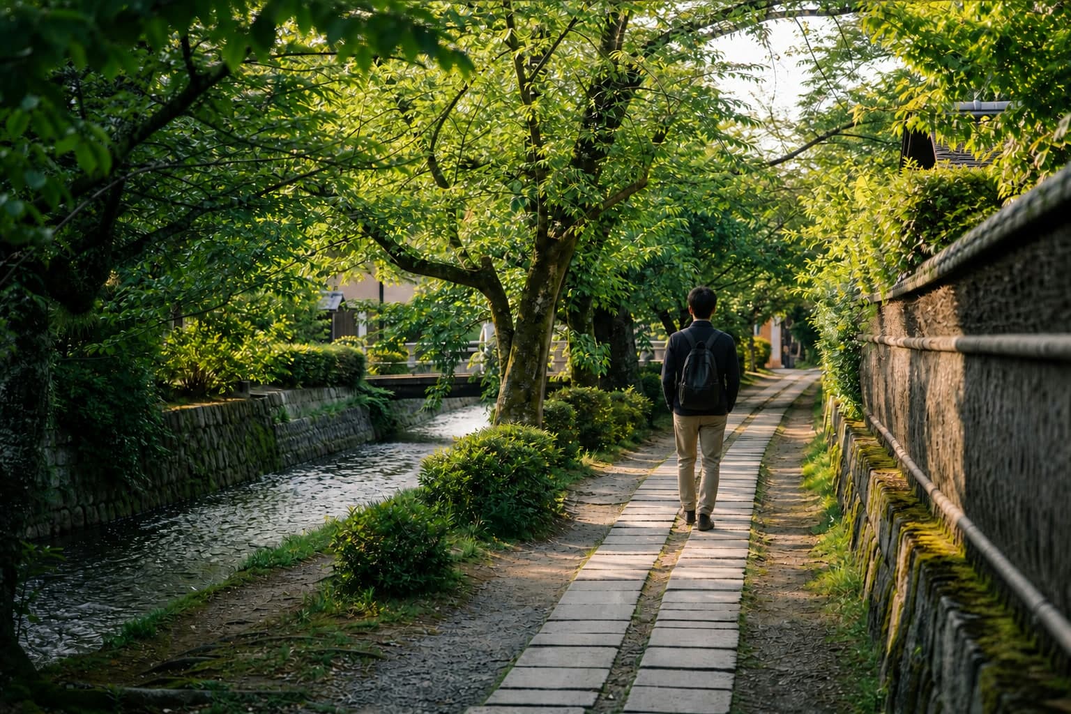Traveler walking beside the Philosopher's Path canal